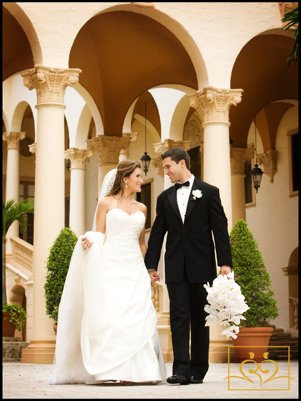 Rachel & Fernando-Wife & Husband stroll in front of the beautiful pillars at the Biltmore Hotel