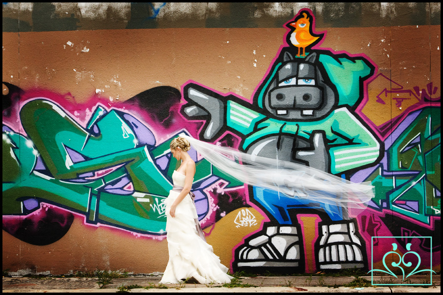 What a great contrast with Alma in a exquisite Vera Wang wedding gown and some great grafiti.